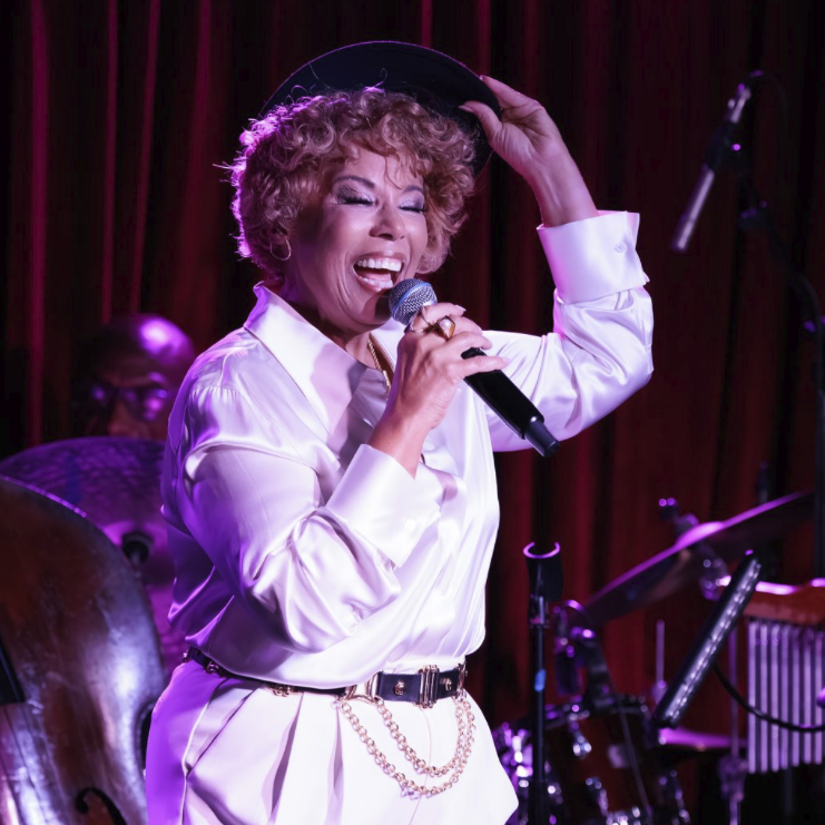 Amber Weekes singing on stage