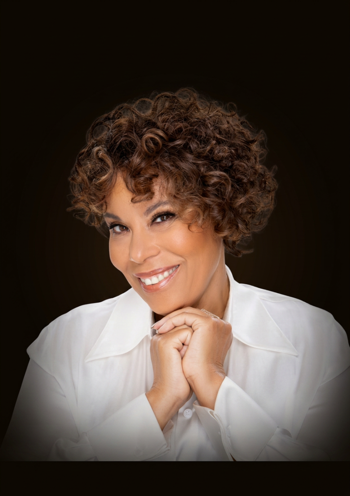 Portrait of Amber Weekes smiling in a white blouse