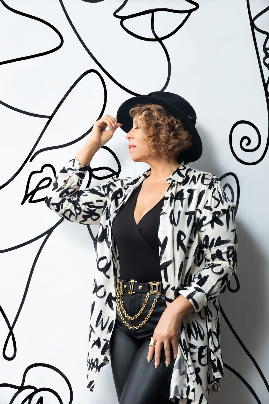 Amber Weekes performing against illustrated artwork
